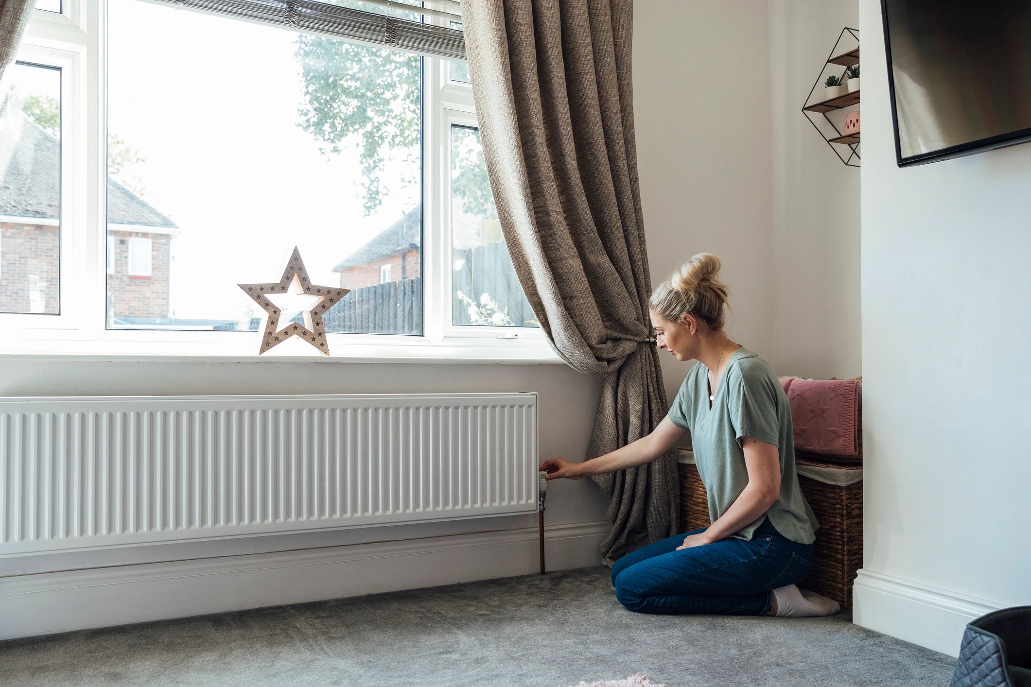 Resident adjusting home heating controls